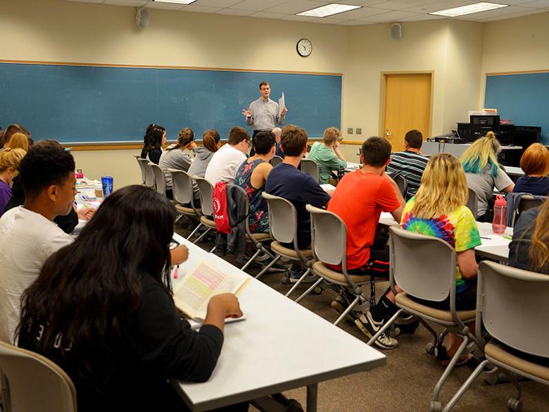 A history professor teaching in a classroom full of students